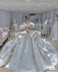 a woman is taking a selfie in a wedding dress made out of mannequins