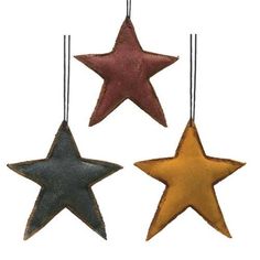 three star ornaments hanging from strings on a white background, each with different colors and sizes