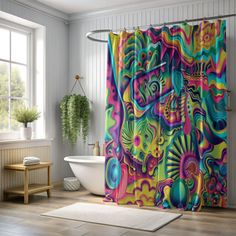 a colorful shower curtain in a bathroom next to a bathtub and window with potted plants