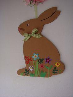 a paper cut out of a rabbit with flowers