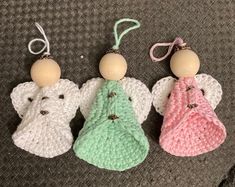 three crocheted angel ornaments are sitting on the floor next to each other,