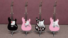 three guitars with hello kitty designs on them are lined up in a row, one is pink and the other is black