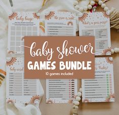 the baby shower games bundle is laid out on a blanket