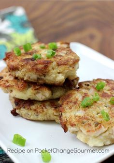 mashed potato and stuffing patties with green onions on a white square plate, ready to be eaten