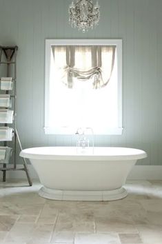 a white bath tub sitting next to a window