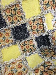 a yellow and black quilt with sunflowers on it