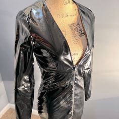 a mannequin's torso is covered in black plastic and sits on display