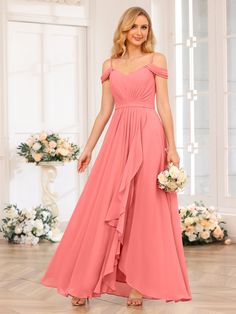 a woman in a long pink bridesmaid dress standing on the floor with flowers