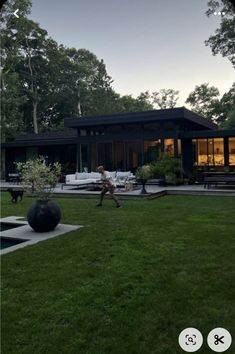 a person running in the grass near a house