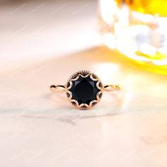 a black diamond ring sitting on top of a table