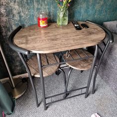 two chairs and a table in a room with flowers on the floor next to each other