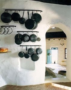 pots and pans are hanging on the wall