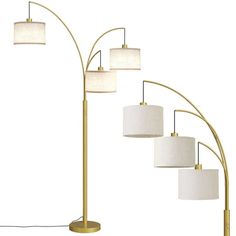 a set of four lamps with white shades on them and one light in the middle