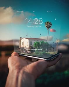 a person holding up a cell phone with the screen showing an image of a house and palm trees