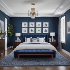 a bedroom with blue walls and pictures on the wall above the bed, along with an ottoman