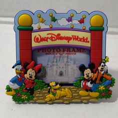 Authentic Disney Parks Walt Disney World Mickey & Pals Gate Photo Frame 2x3 Magnet Walt Disney World Gate Way Entrance Display Represents The One In Orlando Florida Brand New Photo Frame Self Standing Or Magnetic Features The Famous Walt Disney World Property Gate And Mickey And His Pals Minnie, Pluto, Goofy And Donald Duck Size" 4 1/2" (W) X 4" (H) Pvc Photo Size Holds 2" X 3" Disney Photo Frames, Disney Picture Frames, Mickey Mouse Bedding, Mermaid Pictures, Walt Disney World Vacations, Disney Home, Disney Theme Parks, Disney Theme, Mickey Mouse And Friends