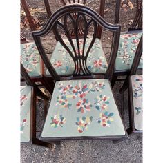 four chairs with floral upholstered back cushions