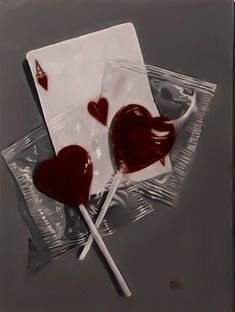 two heart shaped lollipops sitting on top of each other