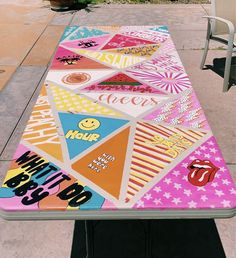 a table that has been painted to look like it is on the sidewalk with some writing on it