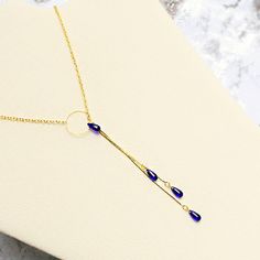 This necklace is created using high-quality Czech glass beads in the shape of smooth teardrops. Nice cobalt blue and gold necklace for you. This necklace features a ring that helps you to regulate the length of the necklace. The chain is brass with an anti-allergenic gold color coating. The length is 20 inches (50 cm). The drop pendant length is 3.75 inches (9.5 cm). 1 Cobalt Blue 2 Bright Blue Matte 3 Light Blue Matte 4 Luster Grey 5 Pink 6 Bright Red 7 Red Matte 8 Ruby Red 9 Emerald Green 10 O Adjustable Clavicle Chain Drop Necklace, Party Clavicle Chain Jewelry With Teardrop Pendant, Party Jewelry With Delicate Chain And Teardrop Pendant, Party Jewelry With Delicate Teardrop Pendant, Party Teardrop Pendant With Delicate Chain, Delicate Teardrop Pendant For Party, Teardrop Adjustable Chain Jewelry For Gifts, Teardrop Adjustable Chain Jewelry Gift, Drop Lariat Necklace With Clavicle Chain For Gifts