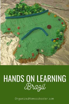 a cake with green frosting on it and the words hands on learning brazil