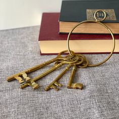 a bunch of keys sitting on top of a table next to a stack of books