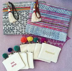 four small pouches with tassels and pom - poms on them