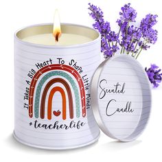 a tin with a candle and some purple flowers