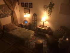 a dimly lit bedroom with a bed, chair and television in the corner at night