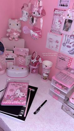 a table topped with lots of pink decorations and items on top of it's surface