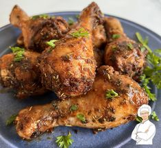 chicken wings with herbs and seasoning on a blue plate