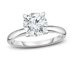 a white gold engagement ring with a round diamond in the center, on a white background