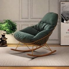 a green rocking chair sitting on top of a rug next to a potted plant