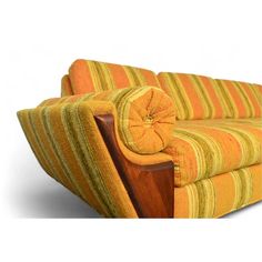 an orange and yellow striped couch sitting on top of a white floor