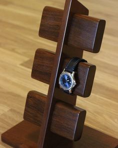 a wooden stand with a watch on it