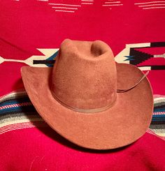 Vintage "Beaver Hats Co." cowboy hat in rare rust/burgundy/brown color. In good vintage condition but does have some slight discoloration staining around the base of the crown, most likely from some adhesive for a retro-fitted feather hat band found with this hat. Am including a new feather hat band with sale and can be put on if desired. (I believe the adhesive can be removed with a bit of effort but I'm not wanting to try) Selling as is. It still looks great. These hats are sought after for th Feather Hat Band, Cowboy Oc, Beaver Hat, Feather Hat, Hat Band, Cowboy Hat, The Crown, Oklahoma, Brown Color