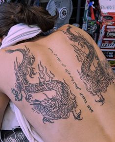 a woman with a dragon tattoo on her back