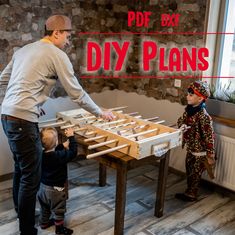 a man standing next to a little boy in front of a table filled with wooden planks