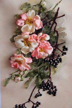 an arrangement of flowers and berries on a table