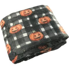 a black and white checkered blanket with pumpkins on it