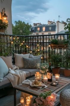 an outdoor patio with candles and flowers on the table