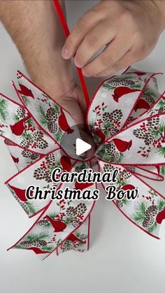 someone is making a christmas bow out of paper