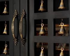 the bells are hanging on the black door