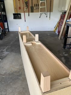 a large wooden object is being built in a garage