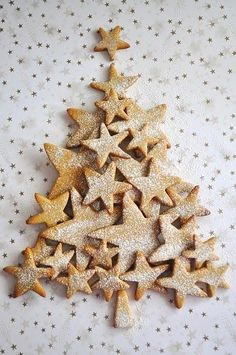 a christmas tree made out of cookies on top of a sheet of paper with stars