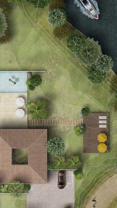 an aerial view of a house with a boat in the water