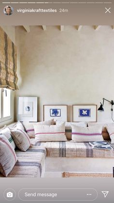 a living room filled with furniture and pictures on the wall