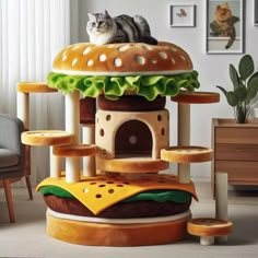 a cat is sitting on top of a hamburger shaped house that's built into the floor