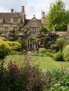 an image of a house in the middle of some bushes and flowers, with text overlay that reads pin it