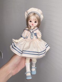 a doll is being held up by a hand